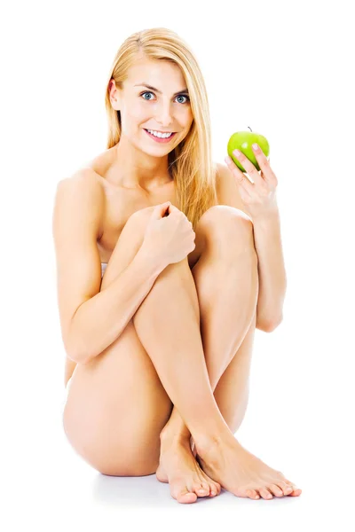 Mujer desnuda sosteniendo manzana sobre fondo blanco — Foto de Stock