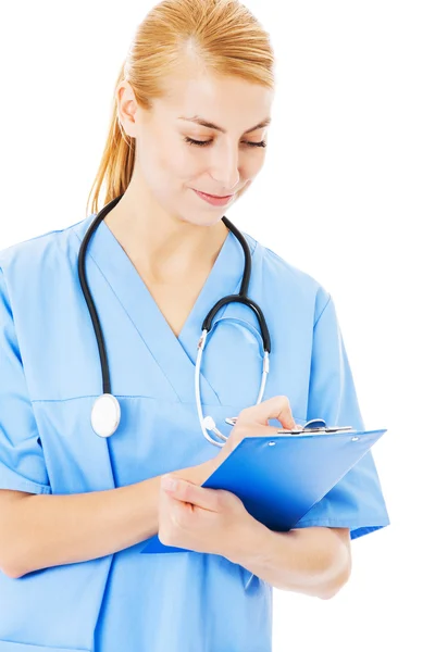 Nurse Writing On Clipboard Over White Background Stock Image