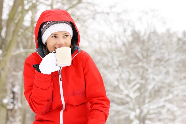 Woman drinking hot drink — Stock Photo, Image