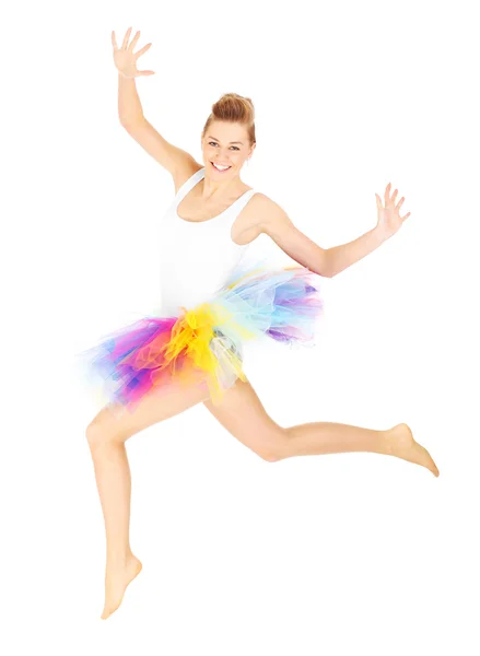 Jumping woman in a colourful skirt — Stock Photo, Image