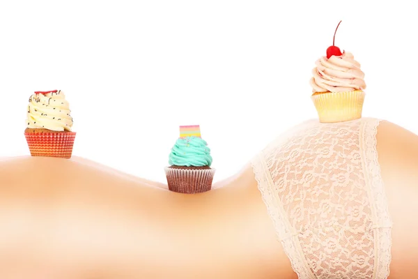Três cupcakes em uma pele feminina — Fotografia de Stock