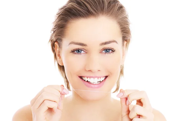 Woman with teeth floss — Stock Photo, Image