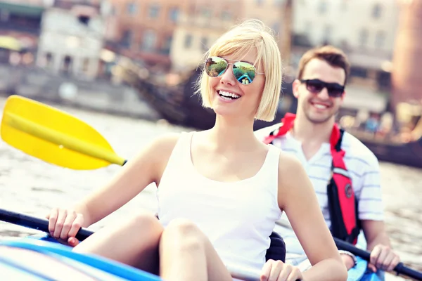 Young couple relaxing in a canoe — Stock Photo, Image