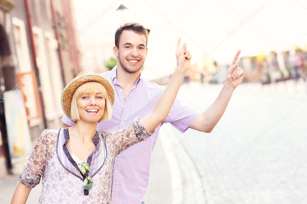Young tourists hailing a taxi