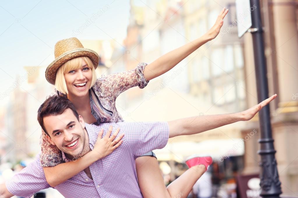 Young crazy couple having fun in the city