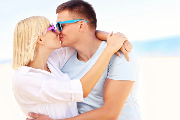 Happy couple kissing at the beach Stock Picture