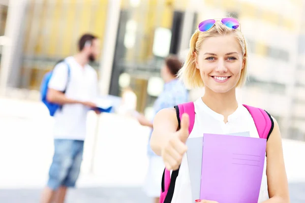 Pretty student showing ok sign in the campus — Stock Photo, Image