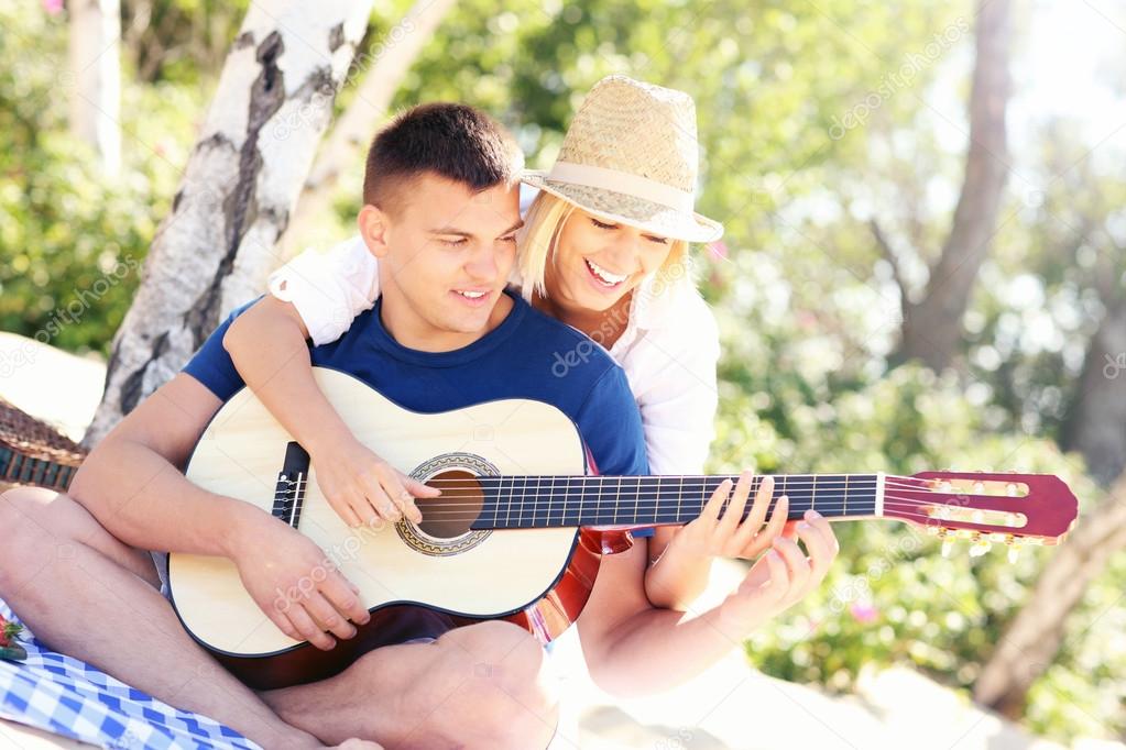Joyful couple and guitar