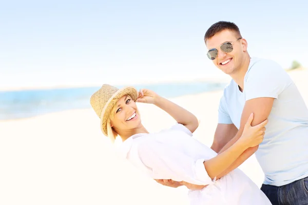 Pareja alegre en la playa — Foto de Stock