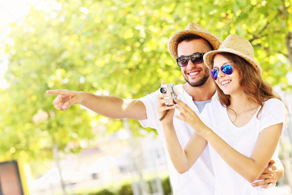 Happy couple taking pictures in the city