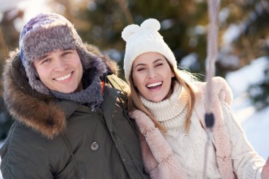 Çiftler kış manzarası ve karda eğleniyor.