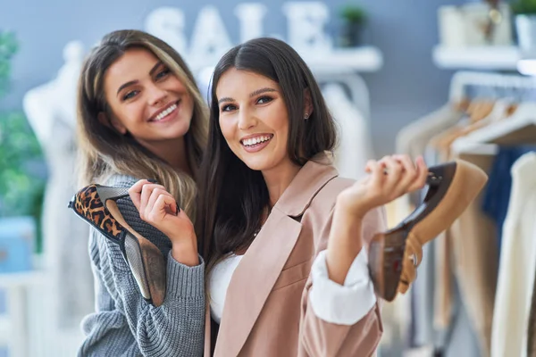 Två glada tjejer på shopping innehav skor — Stockfoto