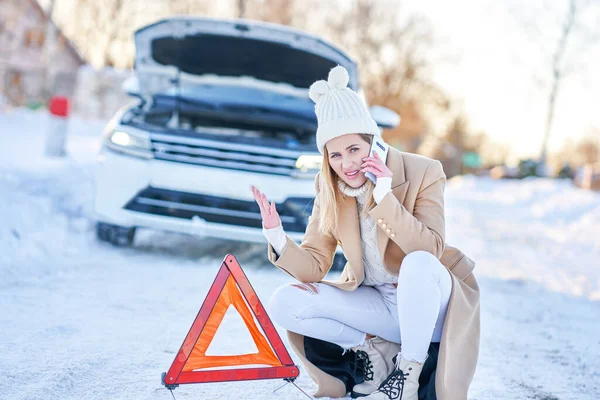 Mujer joven que tiene problemas con el coche en invierno —  Fotos de Stock