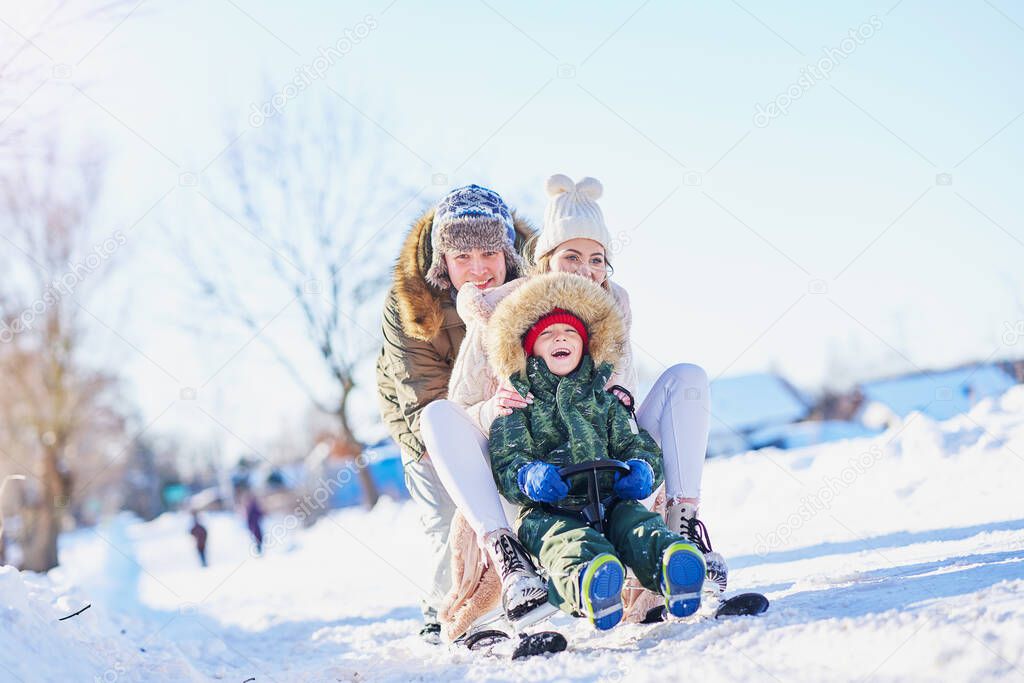 Nice happy family having fun on winter snow