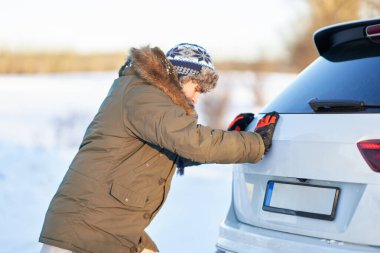 Man having problem with car during snowy winter