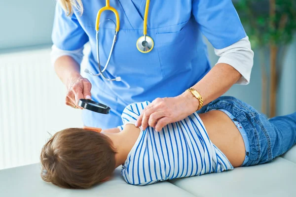 Pediatrician doctor examining little kids in clinic ears check — Stock Photo, Image