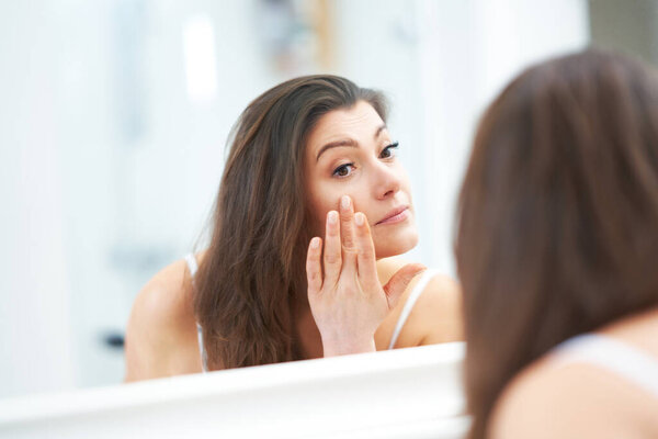 Young nice brunette woman in the bathroom