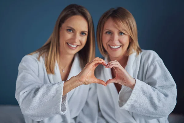 Two girls wearing bathrobe in spa or hotel having fun —  Fotos de Stock