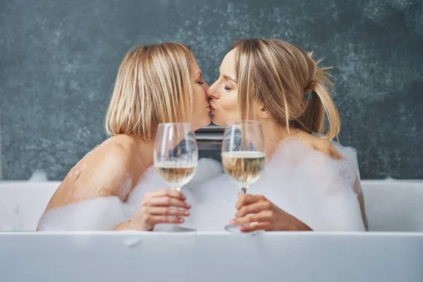 Two girls or couple in bathroom having fun — Stockfoto