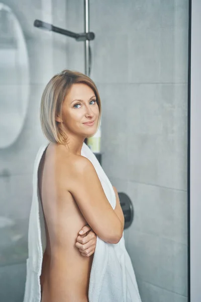 Young nice woman in bathroom preparing herself — Stockfoto