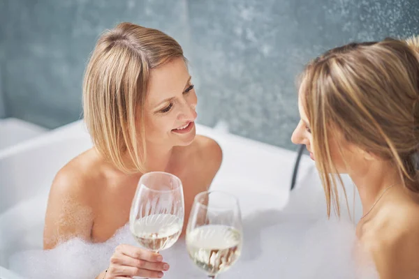 Two girls or couple in bathroom having fun — Stock fotografie