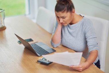 Young woman counting home budget with bills. High quality photo