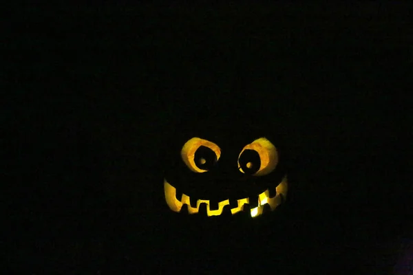 Halloween Pumpkin. Halloween pumpkin in party mood.  Jack O Lantern.  Halloween Jack O Lantern in the dark. Siamese Pumpkin. Angry faced Pumpkin. Glowing in the dark Jack o Lantern. Smiling Evil Pumpkin at night. Trick or treat. scary pumpkin face.