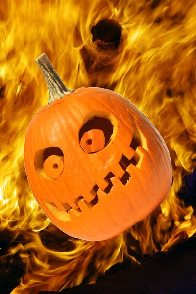 Halloween Pumpkins. Halloween pumpkin in party mood. Jack O Lantern. Isolated on white. Room for text. Halloween pumpkin on fire. Fiery red hot Halloween jack o lantern. Pumpkin carved with scary evil face glowing brightly with thick smoke. Hell Fire