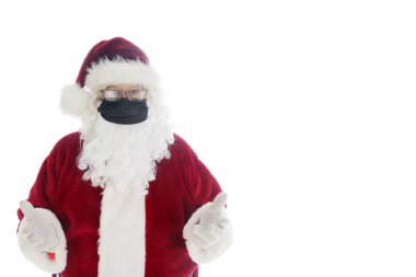 Noel Baba maske takın diyor. Noel Baba, Coronavirus 'u önlemek için tıbbi maske takıyor. Beyazda izole edilmiş. Mesaj için yer var. Covid-19 tehlikelidir. Bu bir COVID-19 Noel. Covid-19 aşısından sonra bile yüz maskesi gereklidir..
