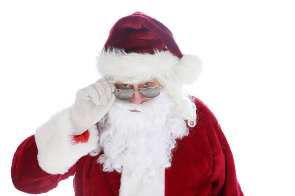 Santa Claus wearing costume and sunglasses. Christmas. Happy Holidays. Santa Claus. Fashion. Santa Claus Christmas. Santa wears his Sunglasses. Room for text. Santa is cool in his hip sunglasses. Merry Christmas to all. Happy Holidays. 