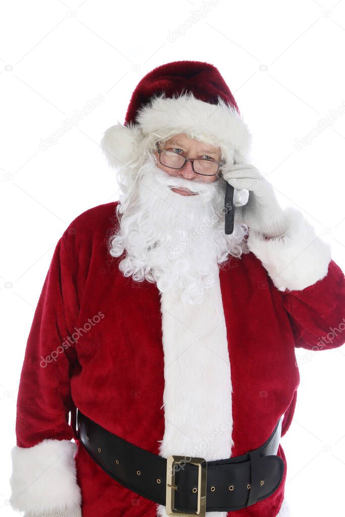 Santa Claus uses his Cellular Telephone. Santa uses his Cell Phone to Text and Send and Take Phone Calls during his busy season. Santa Loves Technology. Merry Christmas. Happy Holidays.