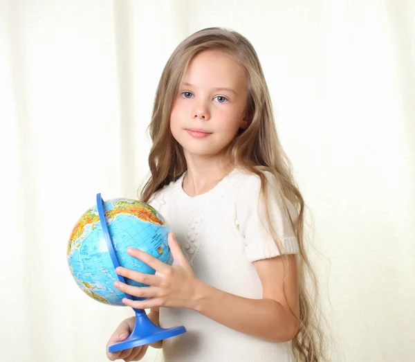 Petite fille blonde cueillant un globe par doigt — Photo