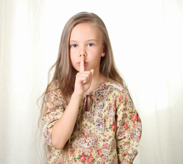 Little blond girl sends air kiss and blowing — Stock Photo, Image