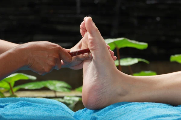 Foot massage by wood stick for Thyroid gland — Stock Photo, Image