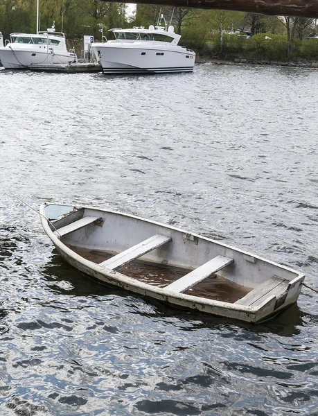 Small sinking boat with water inside