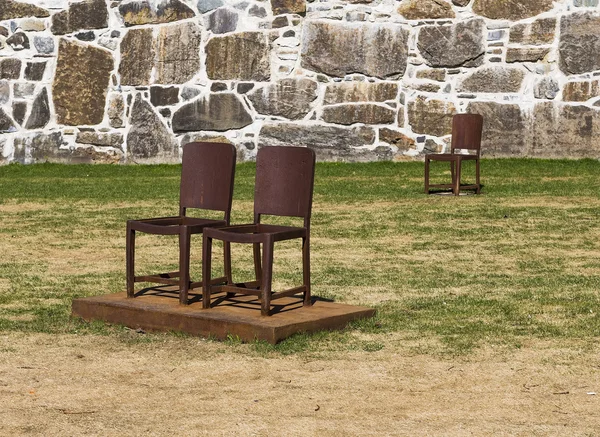 Metal chairs at the walls of the old fortress — Stock Photo, Image