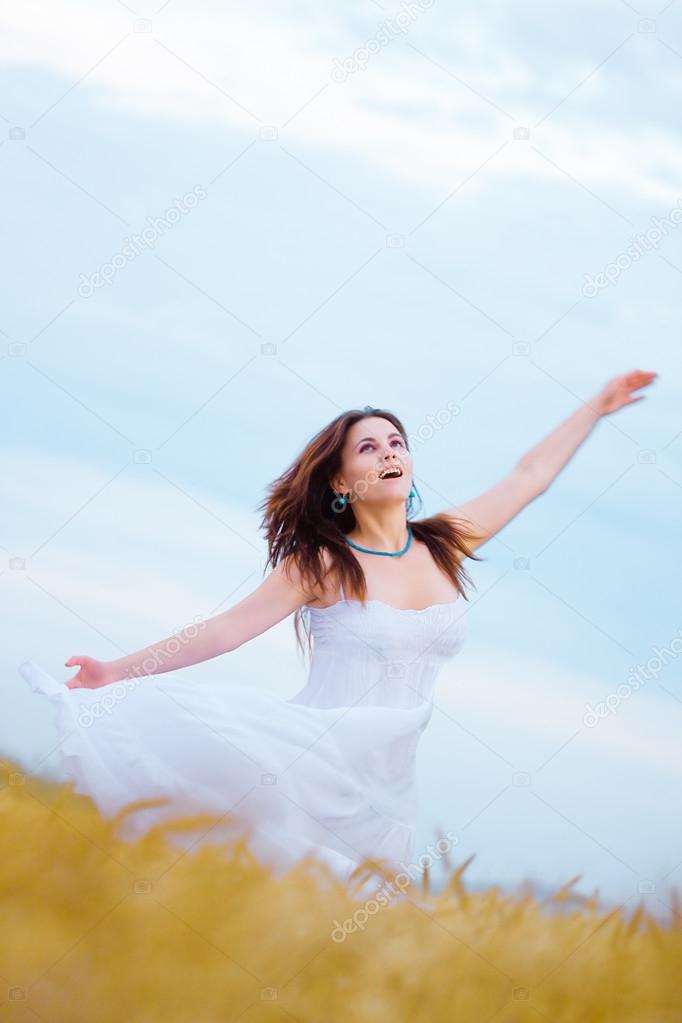 Happy woman in wheat field