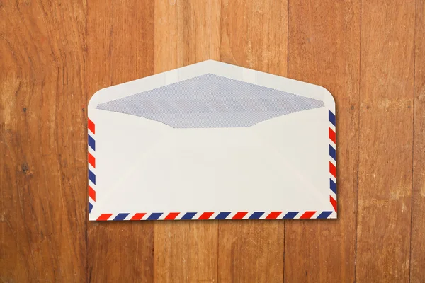 Envelope by air mail isolated on wood — Stock Photo, Image