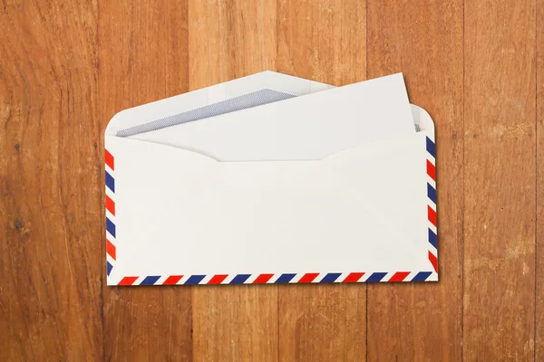 Envelope by air mail isolated on wood — Stock Photo, Image