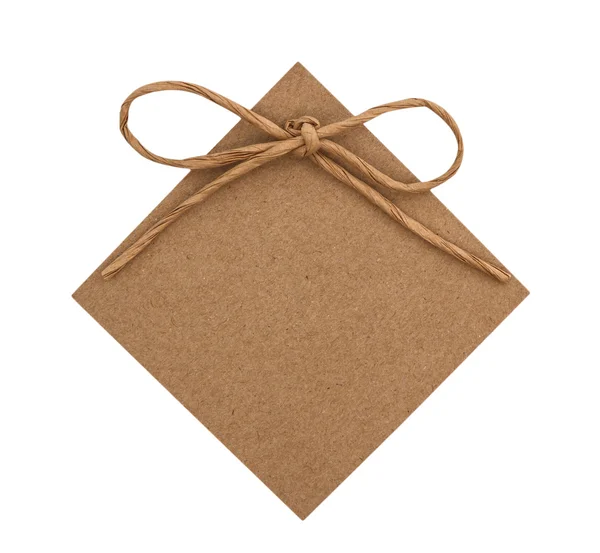 Close up of card note with paper ribbon on white background — Stock Photo, Image