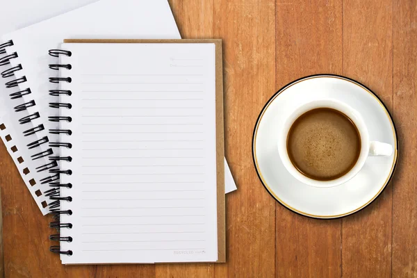 White cup of coffee and notebooks on wood table — Stock Photo, Image