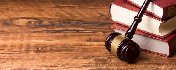 Law concept - Wooden judges gavel and book on table in a courtroom or law enforcement office. Copy space for text. — Stock Photo, Image