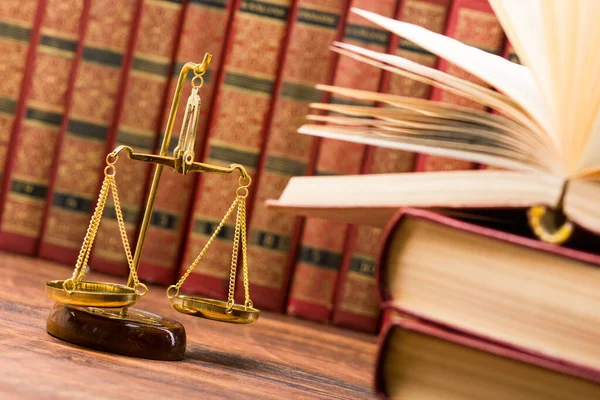 Law concept - Open law book with a wooden judges gavel on table in a courtroom or law enforcement office isolated on white background. Copy space for text