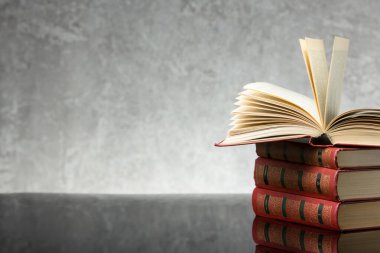 Açık kitap, ahşap masadaki ciltli kitaplar. Okula dönelim. Boşluğu kopyala.