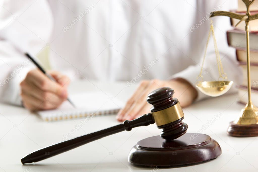 Lawyer working with contract papers and wooden gavel on tabel in courtroom. justice and law ,attorney, court judge concept