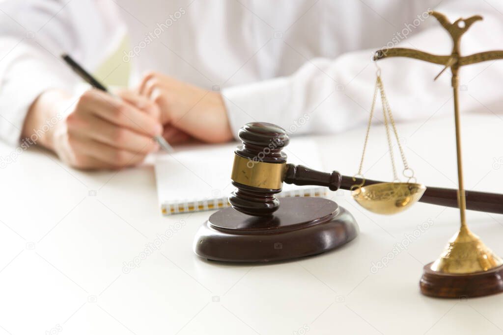 Lawyer working with contract papers and wooden gavel on tabel in courtroom. justice and law ,attorney, court judge concept