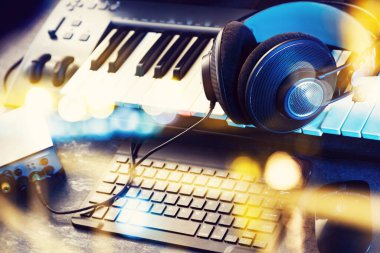 Evde müzik ve dijital stüdyo kaydı. Kulaklık ve ses kartı olan klavye ya da sentezleyici. Bilgisayar kaydı ve müzik üretim konsepti.