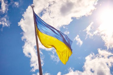 Ukrainian state flag against the sky high