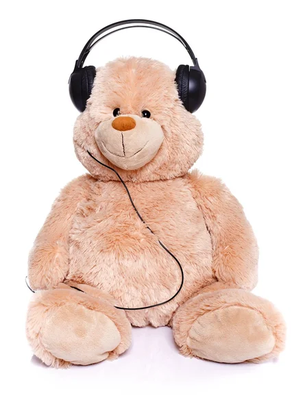 Плюшевий ведмідь слухає музику — стокове фото