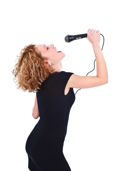 Woman singing in microphone — Stock Photo, Image